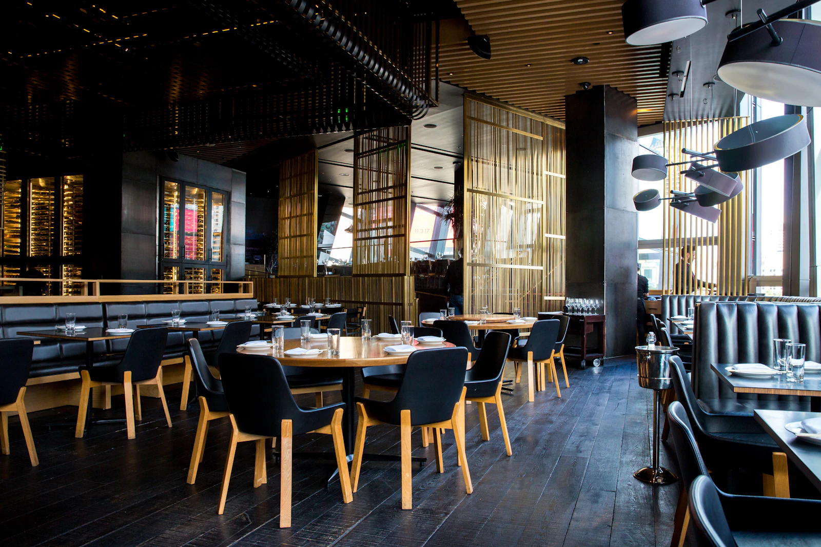 Warm restaurant dining room with wooden tables